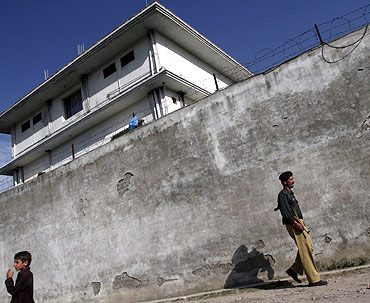 A policeman walks in front of the compound where Al Qaeda leader Osama bin Laden was killed in Abbottabad