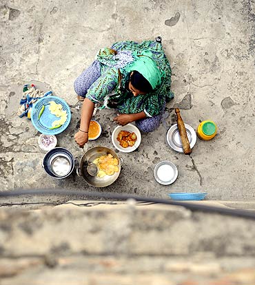 A woman prepares iftar, the evening meal for breaking fast, in the courtyard of her home in Islamabad