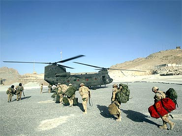 Soldiers board a CH-47 Chinook helicopter in Panjwai district in Kandahar province