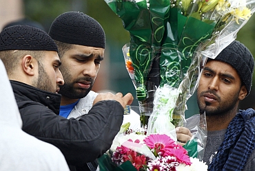 Locals place floral tributes to Asian victims of the riots