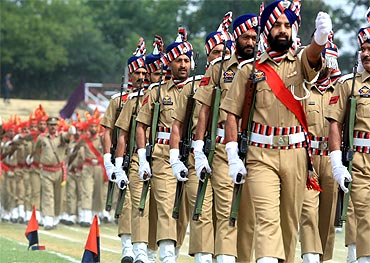 Police personnel march during India's Independence Day celebrations in Srinagar