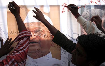 Supporters of Anna Hazare sign a banner outside Tihar jail