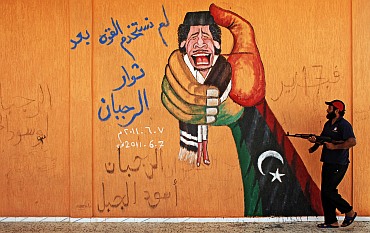 Anti-Gaddafi graffiti is seen on a wall near Yafran in eastern Libya