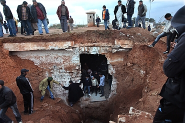 Citizens tour an an underground jail that oppostion supporters excavated at a palace compound of Libyan leader Muammar Gaddafi