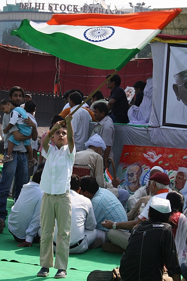 A child waves the tricolour as celebreations break out at Ramlila Maidan on Sunday