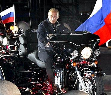 Russian Prime Minister Vladimir Putin rides with enthusiasts during his visit to a bike festival in the southern Russian city of Novorossiisk