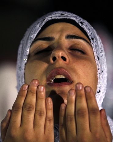 A Muslim woman prays in Jerusalem's Old City