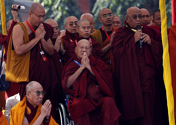 The Dalai Lama prays with other Buddhist leaders and scholars during an all faith prayer meet as part of the Global Buddhist Congregation 2011 in New Delhi