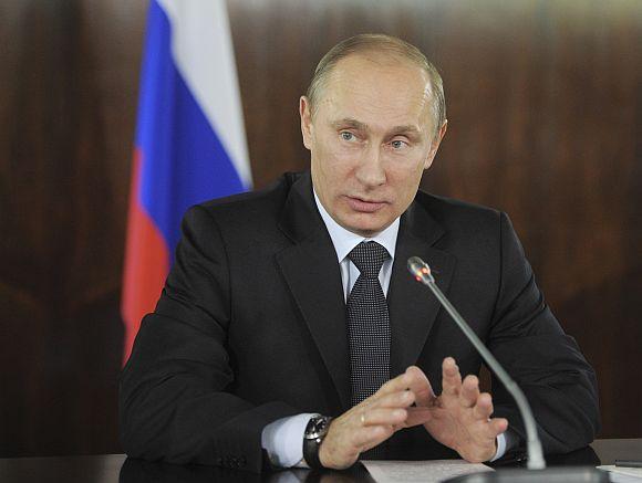 Russian PM Putin gestures during a meeting with organisers of the All-Russian People's Front in Moscow on Thursday