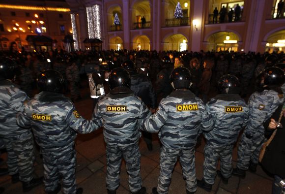 Riot police form a cordon during an opposition protest against the recent election results in St Petersburg