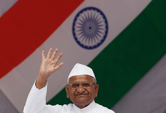 Hazare waves to his supporters  during his day-long fast in New Delhi on December 11
