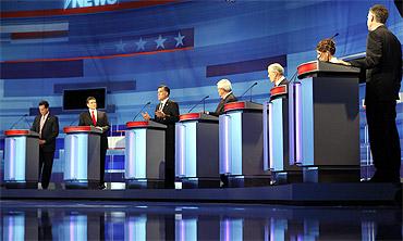 Republican presidential candidates (L-R), former Pennsylvania Senator Rick Santorum, Texas Governor Rick Perry, former Massachusetts Governor Mitt Romney, former House Speaker Newt Gingrich, Representative Ron Paul (R-TX), Representative Michele Bachmann (R-MN), and former Utah Governor Jon Huntsman participate in a Republican presidential debate in Sioux City, Iowa, December 15, 2011