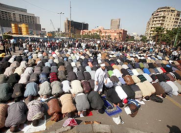 Protesters pray in Tahrir square during an anti-Mubarak protest in Cairo on Tuesday