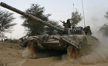An Indian army tank moves during an army exercise at Pallu, Rajasthan
