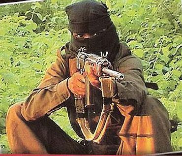 A Maoist trains his gun, somewhere in Central India