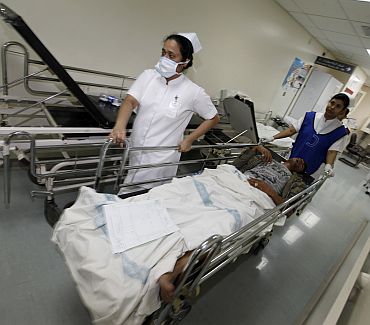 A Bahrain protester injured during clashes with police is rushed to an operation theatre in Manama