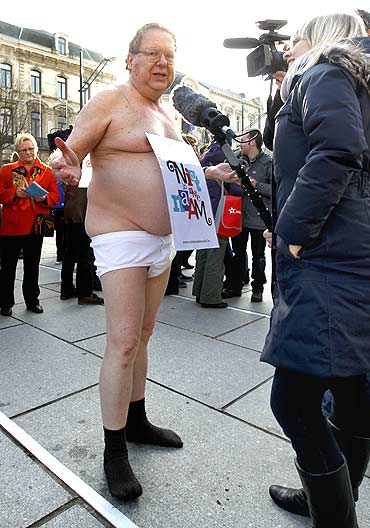 A Belgian demonstrator takes part in a mass striptease