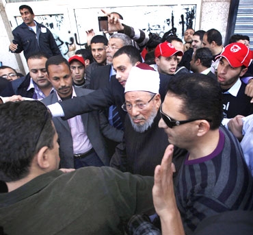 Egyptian cleric Sheikh Yousef al-Qaradawi arrives to lead the Friday prayers in Tahrir Square
