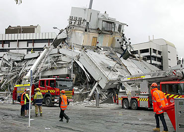 Rescue crews look for staff in a damaged building in central Christchurch