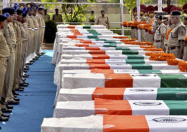 CRPF personnel pay their last respects near the coffins of policemen who died in a Maoist attack