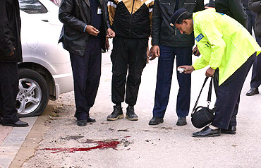 A policeman surveys the site where Salman Taseer was shot dead