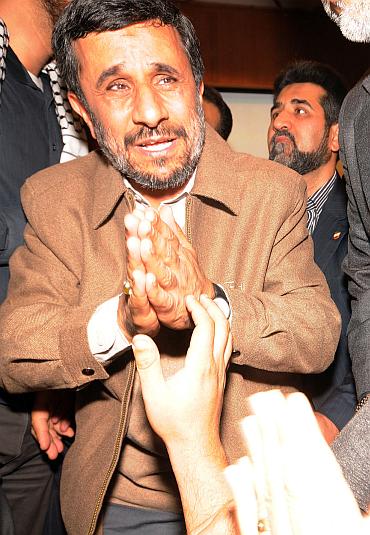 Iranian President Mahmoud Ahmadinejad greets members of the Gaza caravan