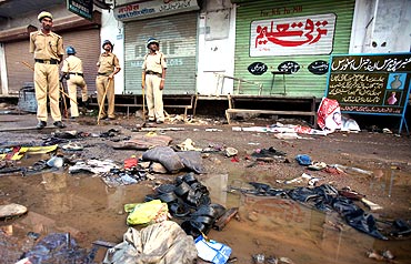 Police officials stand guard at a blast site outside a mosque in Malegaon