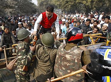 Demonstrators scuffle with security personnel during a demonstration in protest against efforts by local authorities to demolish what police described as an illegally built mosque in New Delhi
