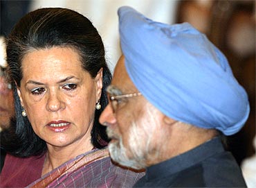Congress chief Sonia Gandhi talks with Prime Minister Manmohan Singh during a function in New Delhi
