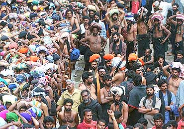 Devotees wait outside the Sabarimala Temple to offer prayers to Lord Ayyappa in Pathanamthitta in Kerala