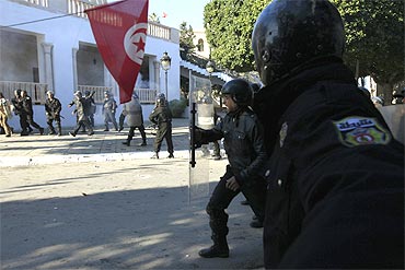 Tunisian riot police clash with protesters near government offices in the Casbah, the old city of Tunis