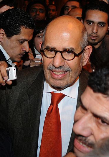 Egyptian reformed campaigner Mohamed ElBaradei talks to journalists outside Cairo's airport