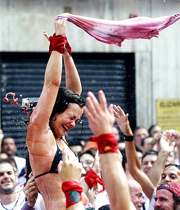 A reveller gets sprayed with wine during the start of the San Fermin Festival