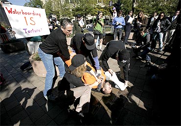 Demonstrator Maboud Ebrahimzadeh is held down during a simulation of waterboarding outside the Justice Department in Washington