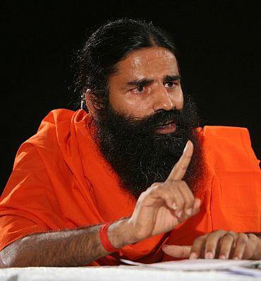 Protestor throws black ink at Ramdev, beaten up - Rediff.com News