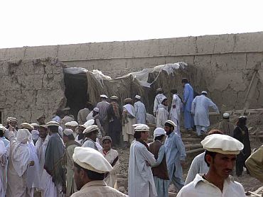 Tribesmen gather after a missile attack near the town of Wana in South Waziristan