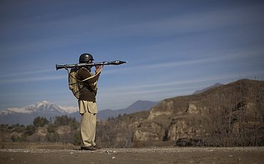 Pakistani soldier Hamed holds a rocket launcher while securing a road in Khar, the main town in Bajaur Agency, in Pakistan