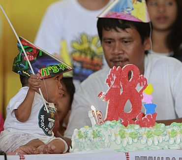 Junrey Balawing blows candle as he celebrates his 18th birthday