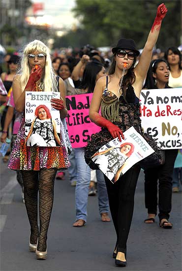 Activists gesture as they take part in the March of Bitches to protest against discrimination and violence against women in Tegucigalpa