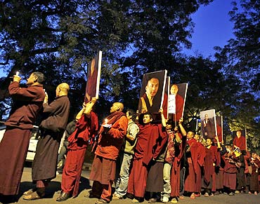 Buddhist monks attend a candlelight vigil in support of Karmapa Lama in New Delhi on February 11, 2011