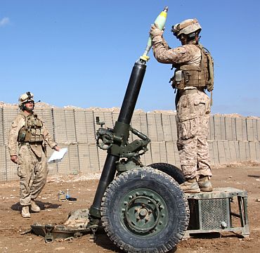 US Marines with the Battalion Landing Team 3/8, 26th Marine Expeditionary Unit, Regimental Combat Team 8, prepare to fire a 120mm mortar at Combat Outpost Ouellette, Helmand province, Afghanistan, March 6, 2011. This was the first time the new Advanced Field Artillery Tactical Data System's Ballistic Computer 11 software was used in the field