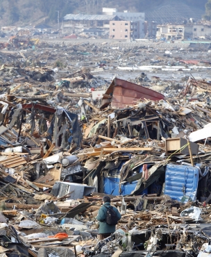 A man looks at rubble in Rikuzentakata, northern Japan
