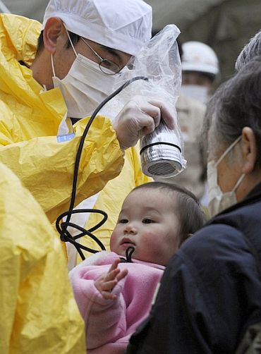 A baby is tested for radiation poisoning at a shelter in Fukushima Prefecture