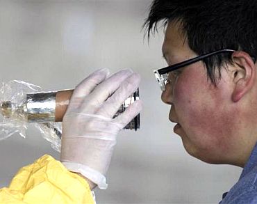 A man who was evacuated from the vicinity of Fukushima's nuclear power plants is screened for radiation levels at a makeshift facility to screen, cleanse and isolate people with high radiation levels in Nihonmatsu