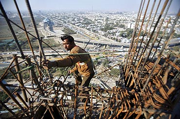 Work at the construction site of a residential complex in Noida, Uttar Pradesh