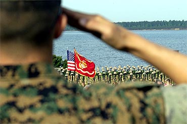 A arine salutes the olours at the start of the 2d Marine Memorial Service for troops who were killed in action during Operation Iraqi Freedom in April, 2006 in Camp Lejeune, North Carolina