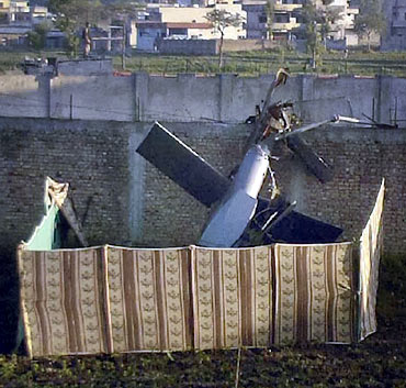 Part of a damaged helicopter is seen lying near Osama's mansion