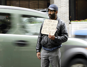 A homeless man begs in Washington
