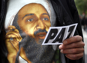 A man wears a T-shirt with the image of Osama bin Laden during a rally