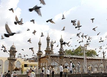 Onlookers gather at the blast site in front of Mecca Masjid